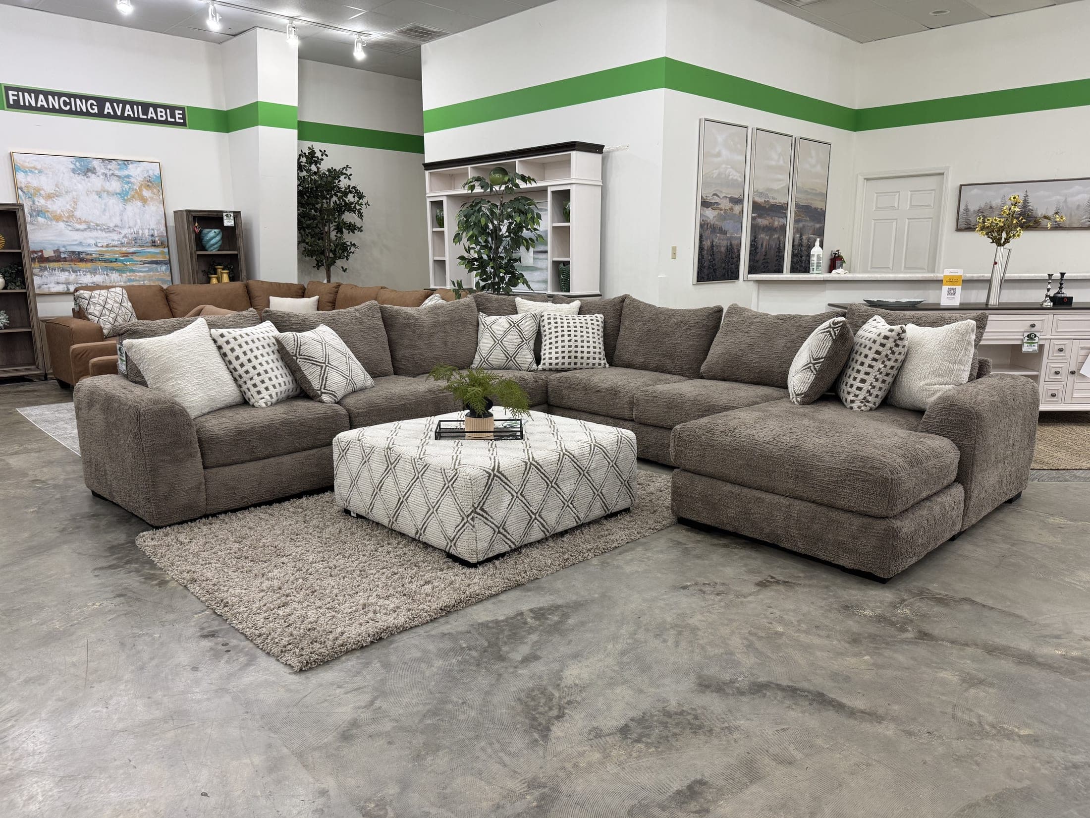 A gray sectional on the LQ floor beneath the store's financing available banner