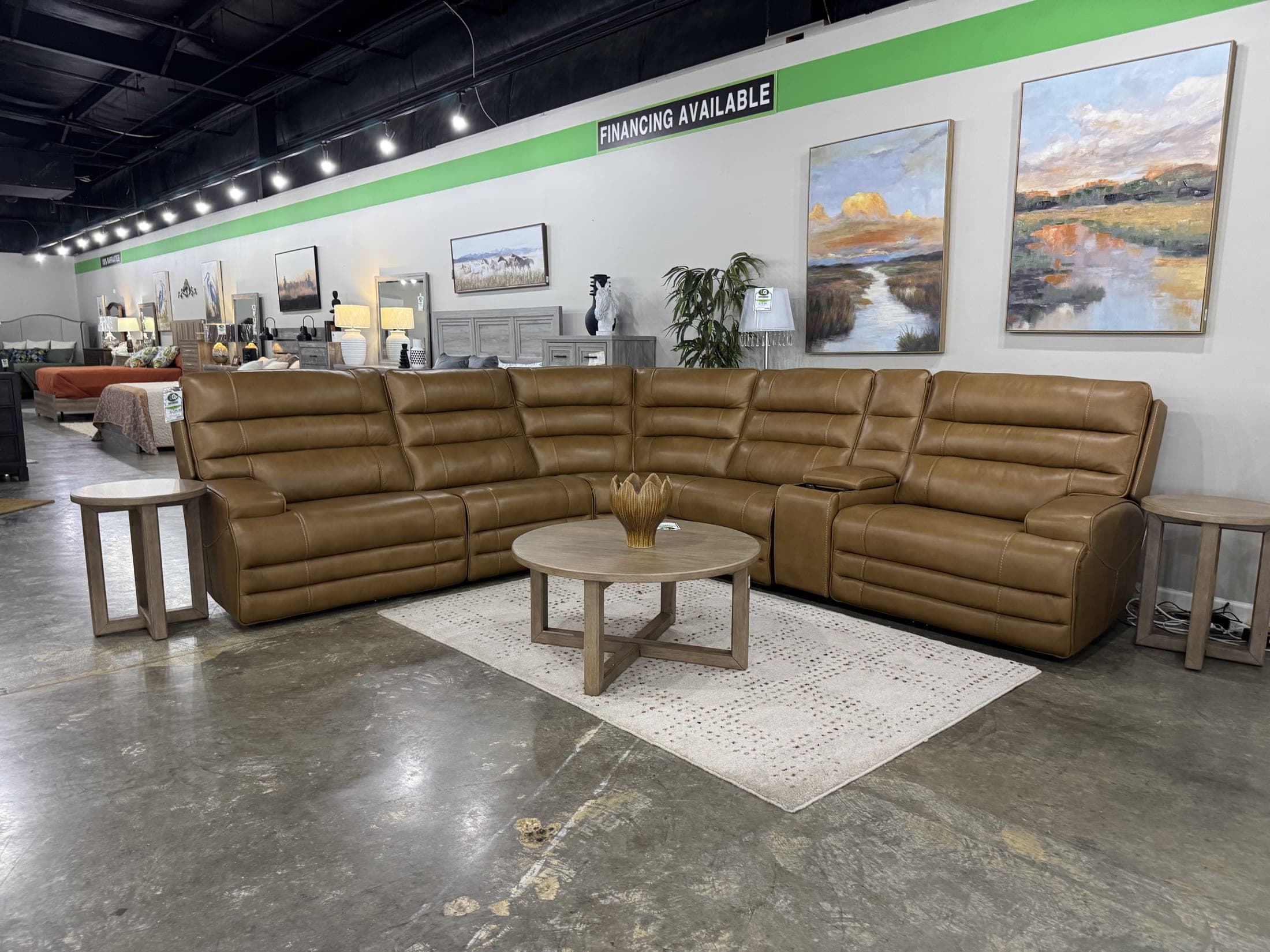 Caramel leather modular sectional arranged in an L on a woven rug