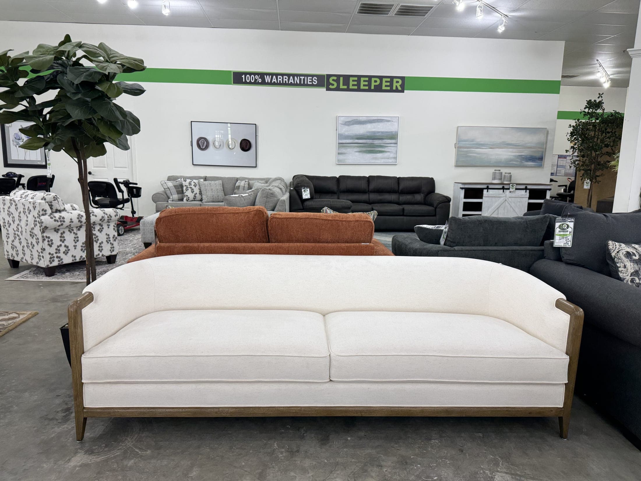 Cream sofa with exposed wood trim and nailhead detail