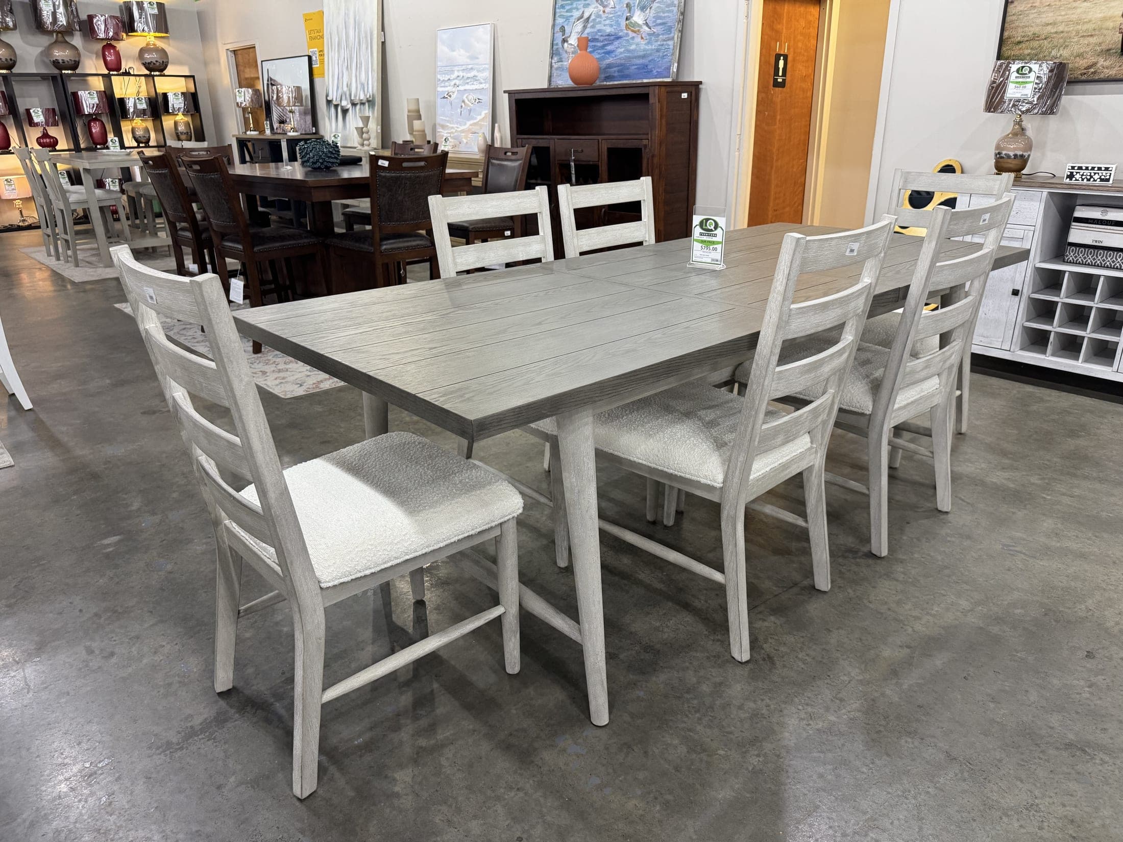 White farmhouse dining table with ladder-back chairs
