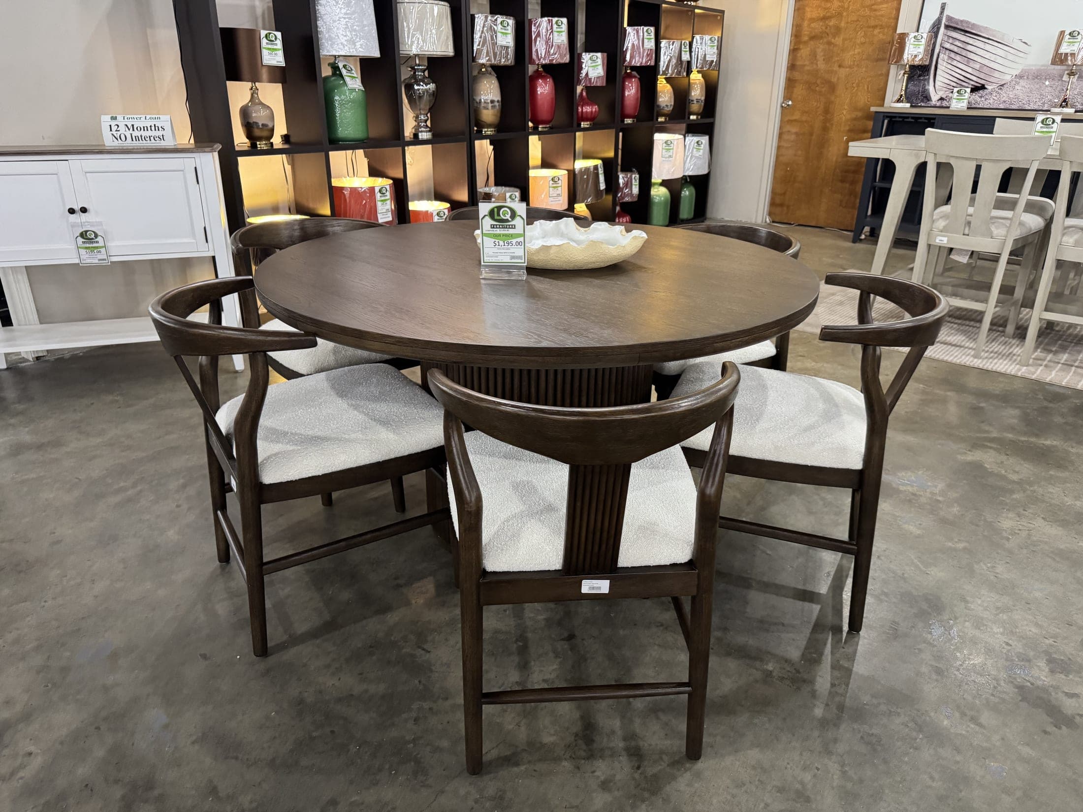 Round walnut table with cream upholstered chairs