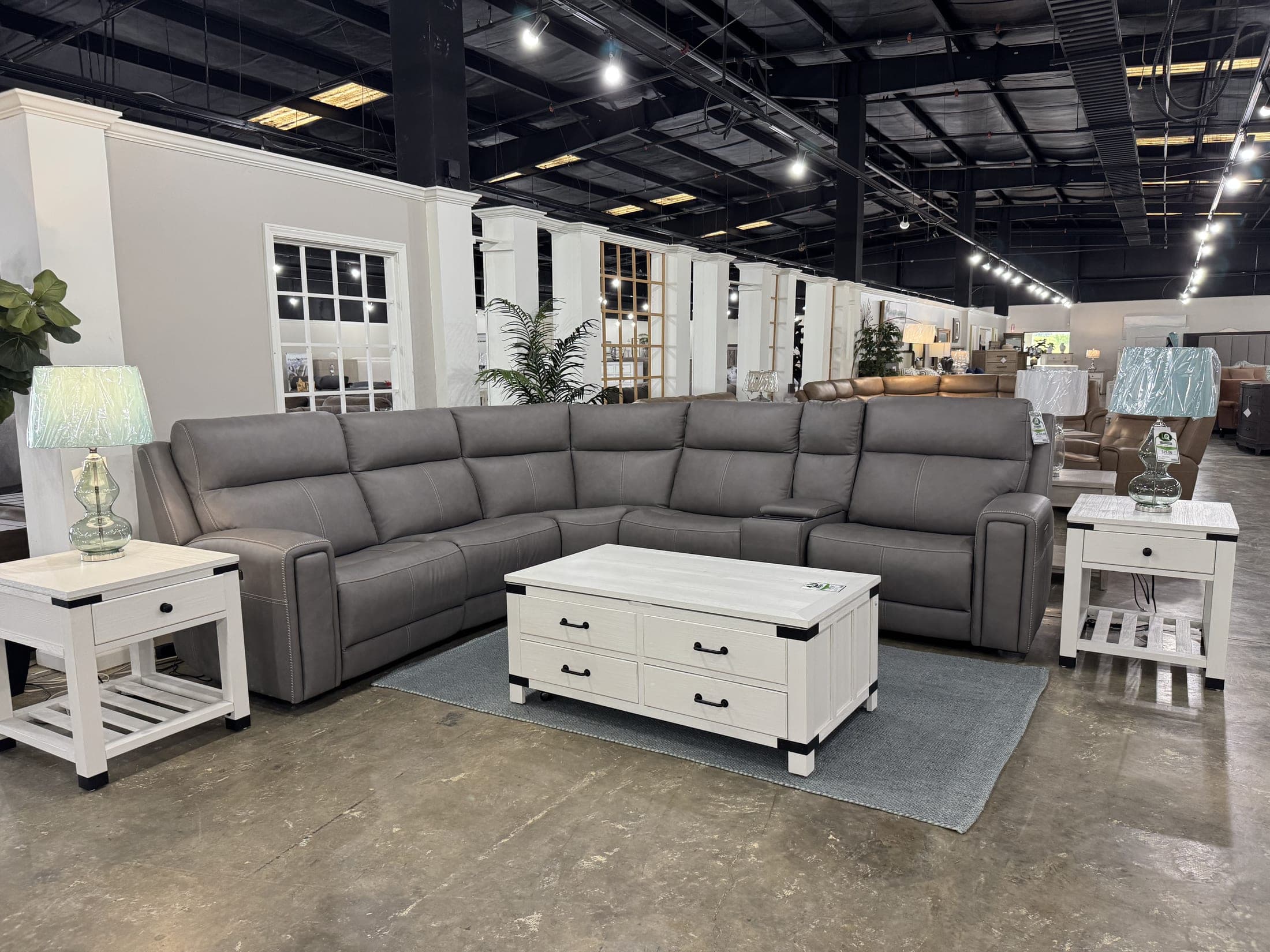 Gray sectional staged with white nightstand tables
