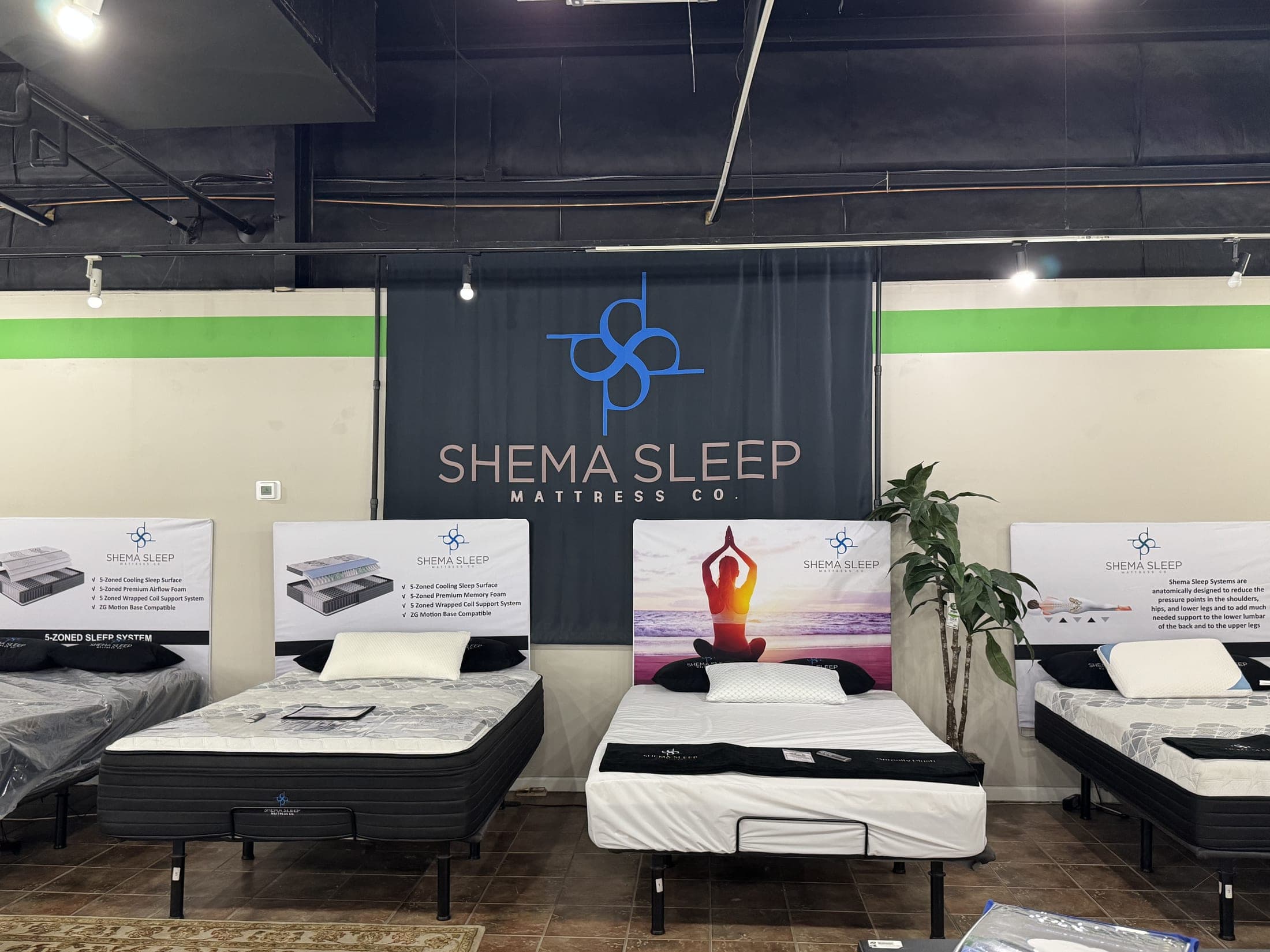 Shema Sleep mattress display under a brand banner