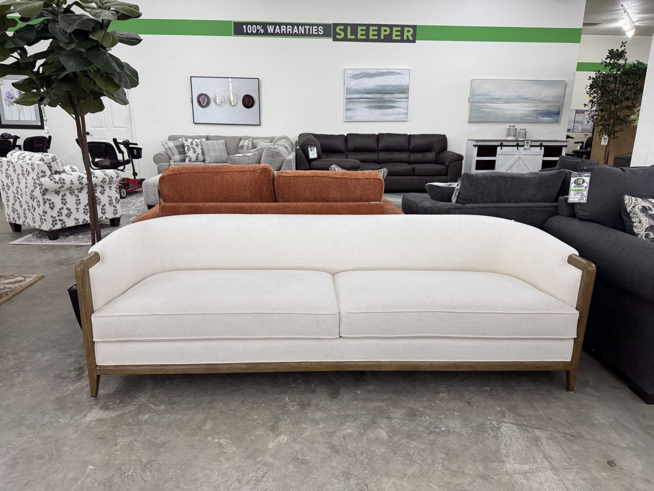 Cream sofa with wood trim beside orange accents
