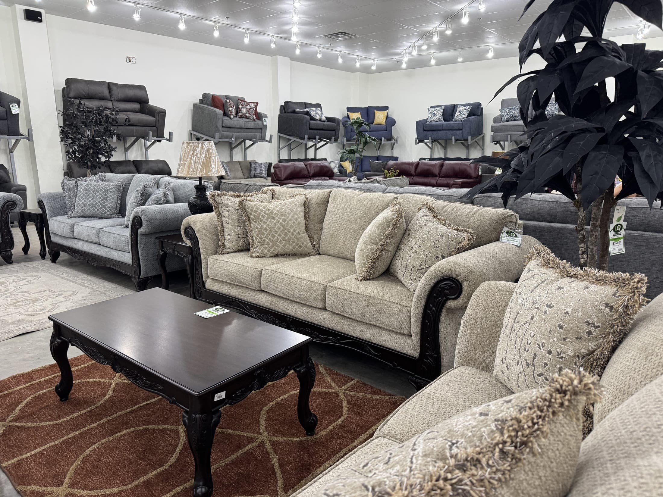 Rolled-arm sofa set with floral accent pillows