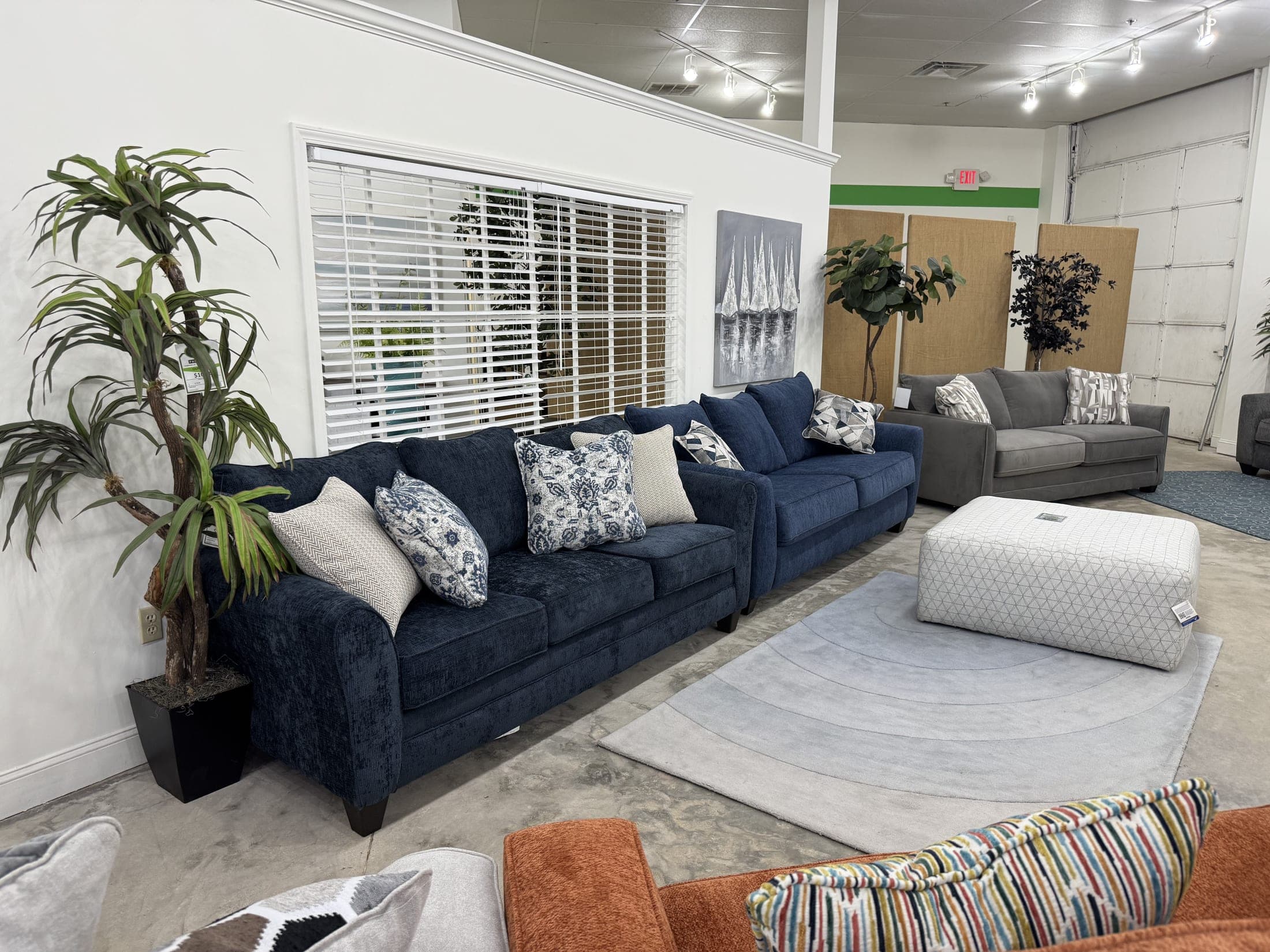 Navy blue sofa and loveseat with accent pillows